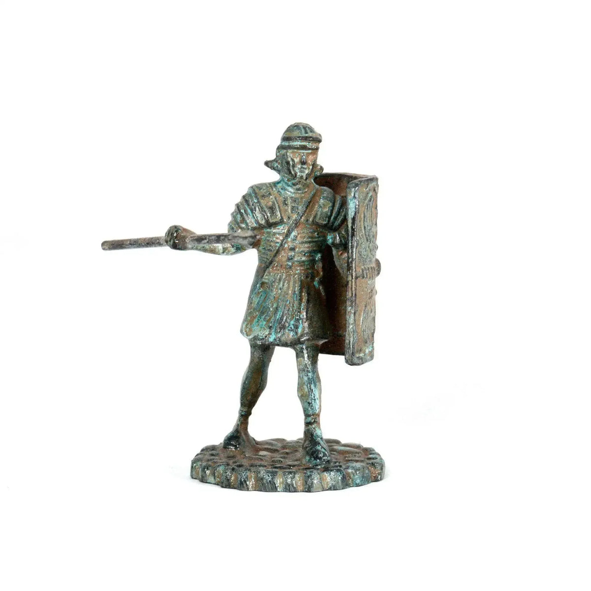 Legionario romano in bronzo con patina verde, visto frontalmente con elmo, lancia e scudo rettangolare, su fondo bianco.