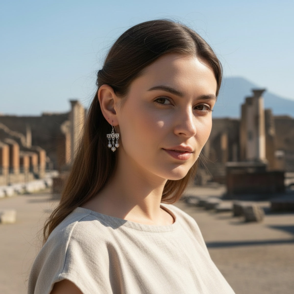 Crotalia earrings with three silver pendants worn