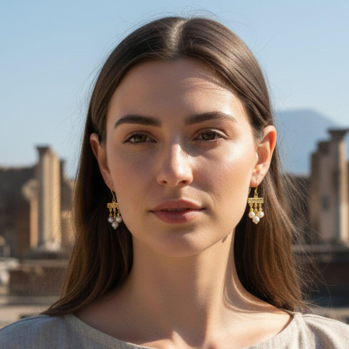 Crotalia earrings with three silver pendants worn