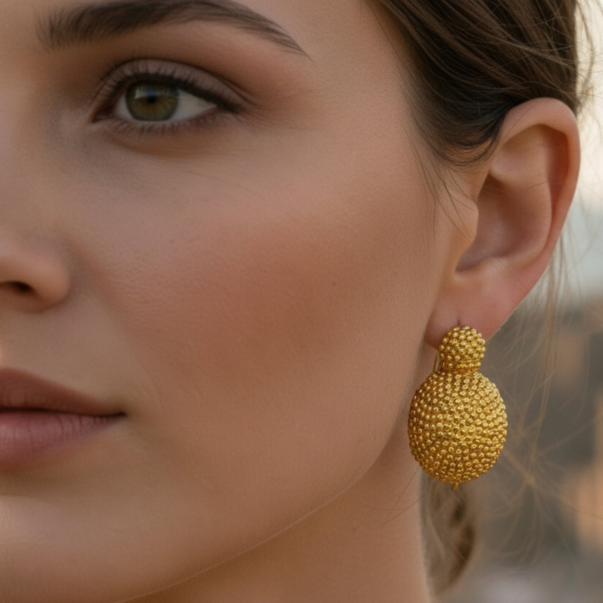 Half-sphere earrings decorated in 925 silver and plated in 18K gold worn