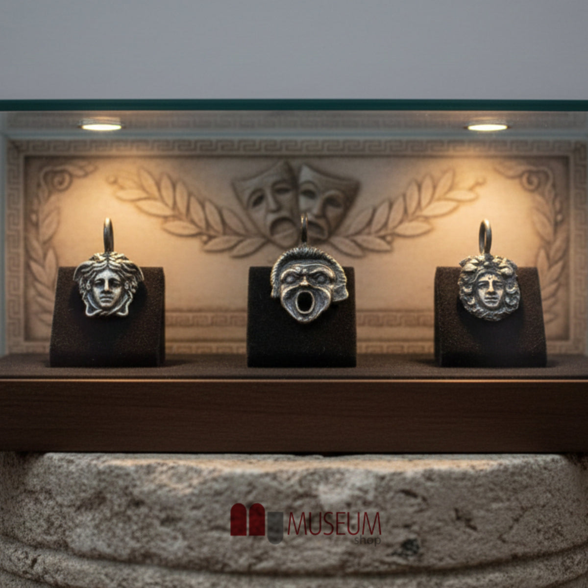 Pendants with Greek Theatrical Masks in 925 Silver displayed in a showcase