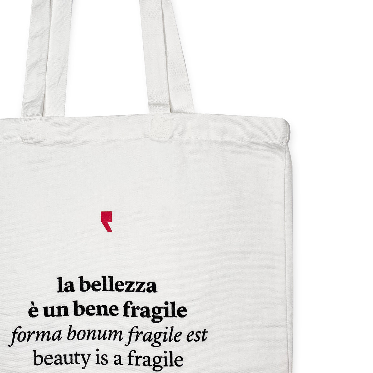 Detail of the phrase "Beauty is a fragile good" printed in black on white cotton shopper – poetic quote by Ovid